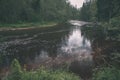 wavy river in forest in green summer - vintage retro look Royalty Free Stock Photo