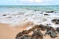 wavy sea with rocks near a beach Royalty Free Stock Photo