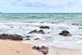wavy sea with rocks near a beach Royalty Free Stock Photo