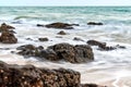 wavy sea with rocks near a beach Royalty Free Stock Photo