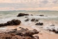 wavy sea with rocks near a beach Royalty Free Stock Photo