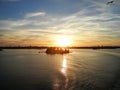 Wavy water, clouds in a sunset and Helsinki panorama