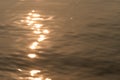 Wavy water surface with glittering orange sun light. 2