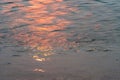 Wavy water surface with glittering orange sun light. 6