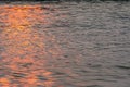 Wavy water surface with glittering orange sun light. 7