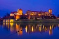 The Wawel Castle of Krakow illuminated at night, reflected on the Vistula River,  Poland Royalty Free Stock Photo