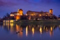 The Wawel Castle of Krakow illuminated at night, reflected on the Vistula River,  Poland Royalty Free Stock Photo