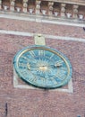 Wawel Cathedral clock on bell tower in Krakow, Poland, gilded sun in the middle and Roman numerals