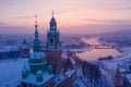 Wawel Royal Castle in winter. Snow on roofs and spires of Wawel castle cathedral and Vistula river Royalty Free Stock Photo