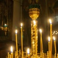 Wax burning candles in an orthodox church on the dark background Royalty Free Stock Photo