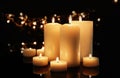 Wax candles burning against blurred lights Royalty Free Stock Photo