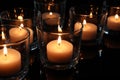 Wax candles burning on table in darkness Royalty Free Stock Photo