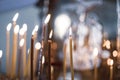 wax candles in the temple next to the cross, the front and back backgrounds are blurred with a bokeh effect