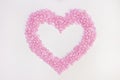 Wax for depilation of pink color. in the form of a heart. On white background. The concept of waxing,