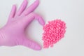 Wax for depilation of pink color. in the form of a heart. On white background. The concept of waxing, smooth skin