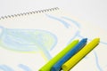 3 wax pencil lying in the albom page with baby pattern, macro shot with selective focus Royalty Free Stock Photo