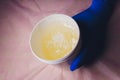 Wax for sugaring in a cosmetic jar in the hands of a master in a beauty salon.