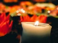 A wax or tallow with a central wick that is lit to produce light as it burns. Many burning candles with shallow depth of field, Royalty Free Stock Photo