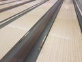 Waxed wooden bowling alley lanes with bumpers Royalty Free Stock Photo