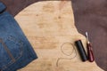 Jeans and leather on wooden background