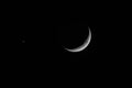Waxing Crescent moon with star against black sky Royalty Free Stock Photo