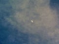 Waxing Gibbous Moon in Blue and Cloudy Sky Royalty Free Stock Photo