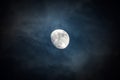 Waxing moon encircled by clouds Royalty Free Stock Photo