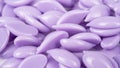 Waxing violet granules lavender isolated on white background. Depilatory hard wax beans. Pearly wax granules from lavender.