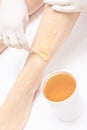 Waxing woman leg. Sugar hair removal. laser service epilation. Salon wax beautician procedure Royalty Free Stock Photo