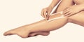 Waxing woman leg with wax strip at beauty spa. Close-up waxing woman leg in spa. Well-groomed woman legs after Royalty Free Stock Photo