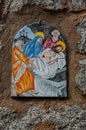 Way of the cross. 14th Station. The body of Jesus is placed in the tomb. Hand painted ceramic tile, Ingurtosu, Arbus, Sardinia Royalty Free Stock Photo