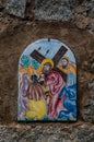 Way of the cross. 8th Station. Jesus comforts the women of Jerusalem. Hand painted ceramic tile, Ingurtosu, Arbus, South Sardinia Royalty Free Stock Photo