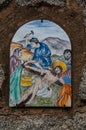 Way of the cross. 11th Station. Jesus is nailed to the cross. Hand painted ceramic tile, Ingurtosu, Arbus, South Sardinia