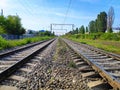 Old rusty way forward railway tracks in bright sunny day. railroad track curve among and blue sky on background, empty railway sor Royalty Free Stock Photo