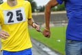 Way of leading blind runner: hand of disabled athlete, on a left, holding hand of healthy one by rope Royalty Free Stock Photo