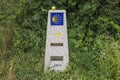 The way marker sign with the yellow shell and arrow, that guides the pilgrims along the Camino de Santiago in Galicia, Spain. Royalty Free Stock Photo