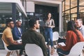 The way a team plays as a whole determines its success. a young businesswoman holding her laptop while giving a business Royalty Free Stock Photo