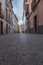 Granada empty narrow streets around Carrera Del Darro. Narrow cobbled streets of Granada in sunshine and blue sky above.