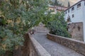 Granada empty narrow streets around Carrera Del Darro. Narrow cobbled streets of Granada in sunshine and blue sky above.