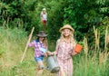 On way to family farm. Taking care of plants. Sisters helping at farm. Girls with gardening tools. Eco farming concept