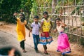 Way to home - indian small girls and boy happily waving greeting and posing to camera