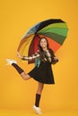 On way to school. Cheerful smiling schoolgirl. Rainy day fun. Happy walk under umbrella. Enjoy rain concept. Kid girl Royalty Free Stock Photo