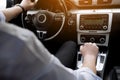 On the way to success. Confident and young businessman in stylish suit is driving his new luxury car and smiling Royalty Free Stock Photo