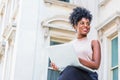 Way to Success. Young African American woman with afro hairstyle wearing sleeveless light color top, sitting by vintage office Royalty Free Stock Photo