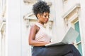 Way to Success. Young African American woman with afro hairstyle wearing sleeveless light color top, sitting by vintage office Royalty Free Stock Photo