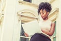 Way to Success. Young African American woman with afro hairstyle wearing sleeveless light color top, sitting by vintage office Royalty Free Stock Photo