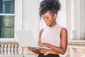 Way to Success. Young African American woman with afro hairstyle wearing sleeveless light color top, standing in vintage office Royalty Free Stock Photo