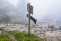 waymark on mountain path in misty spring day Royalty Free Stock Photo