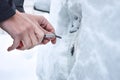 Ways to Open Frozen Car Doors. heating up the key. Male hand opening winter car door with keys, selective focus. Opening,