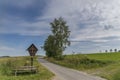 Wayside cross and wooden bench in the Bavarian forest in GrÃÂ¼b by Grafenau Royalty Free Stock Photo